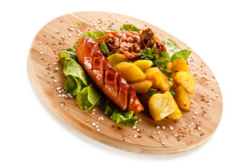 Grilled sausages served on cutting board 