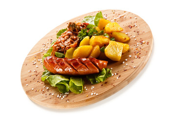 Grilled sausages served on cutting board 