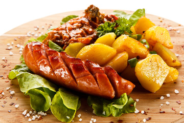 Grilled sausages served on cutting board 