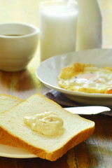 slice bread with fried egg and pork sausage eat couple coffee cup breakfast set