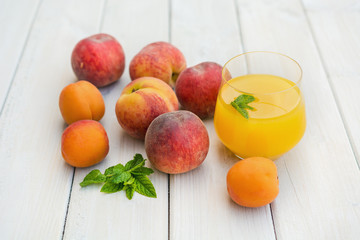 Composition with apricots and nectarines  on a white table