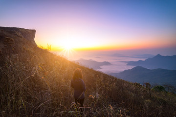 Woman traveler standing looking beautiful mist at sunrise