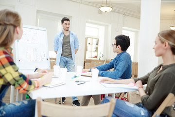 Young designers having talk at meeting