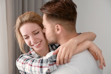 Fototapeta premium Happy young couple near window at home