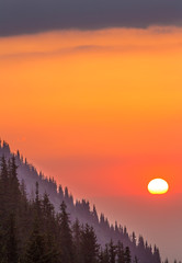 Obraz premium Sunset on the mountainside, orange sky