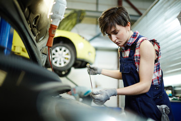 Owner of car service checking up engine