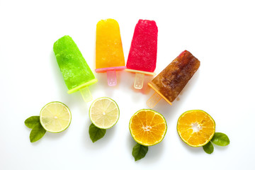 flat lay style of handmade ice cream with lime and orange fruit on white background.