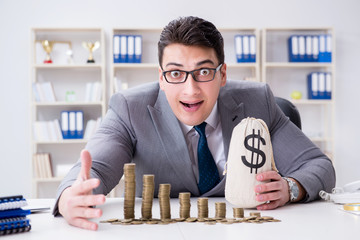 Businessman with golden coins in business growth concept