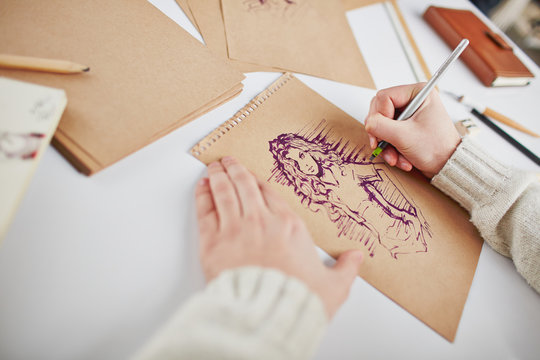 Man Drawing Young Woman On Page Of Notepad