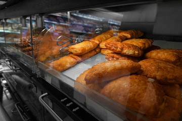 Show-case with delicious fresh bread in bakery