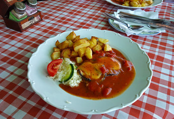 Chicken breast with sauce and roasted potatoes
