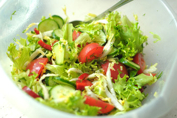 Fresh vegetable salad with tomato, cucumber and salad frisee
