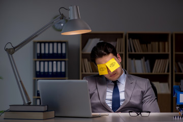Businessman staying late to sort out priorities