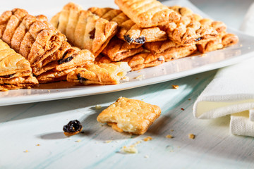 puff cookies with raisins on the plate