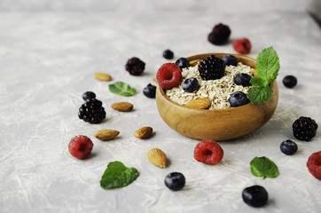 Healthy breakfast with oat flakes, raspberry berries, blueberries, selective focus