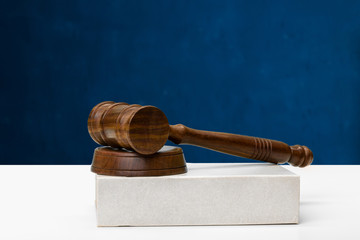 Wooden gavel and books on wooden table