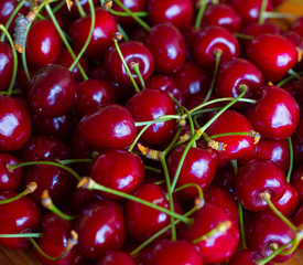 Fresh garden cherry on wooden table. Top view with copy space