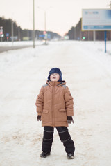 boy walking on a winter street