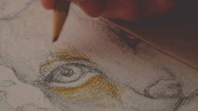 female artist painting a picture of a lynx with a brush on piece of paper