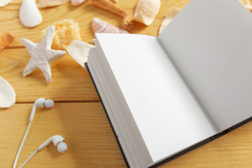 Shells and notepad on wooden table. Top view with copy space