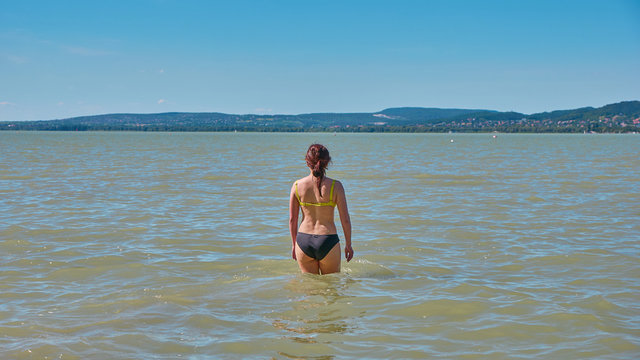 Beautiful girl bathing in Balaton lake