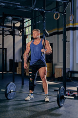 Obraz na płótnie Canvas Bodybuilder holds cross fit hammer.