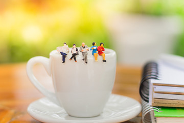 Miniature people : Business team having a coffee break using as business concept.