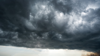 clouds with background,sunlight through very dark clouds background of dark storm clouds,black sky...