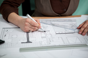 Close up of architect hands working on blueprints. Working on new projects. Architecture and design