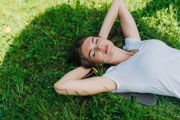 Woman laying on grass in park