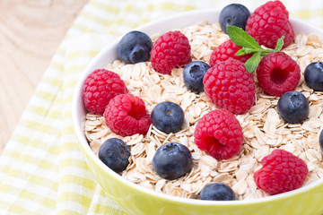 Oatmeal porridge with berries. Raspberries and blueberries.