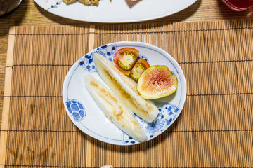 Fresh fruits after breakfast - honeydew melon, fig and tomato.
