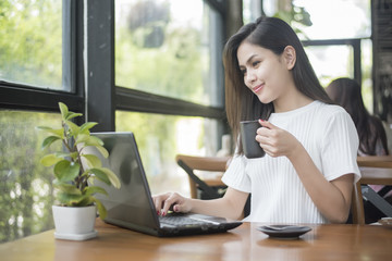  Beautiful business girl working with tablet , smartphone and drinking coffee in coffee shop