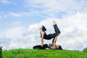 Woman practicing  yoga relax in nature and blue sky background , Yoga Exercise Helps the mind to concentrate, calm and shape and healthy.