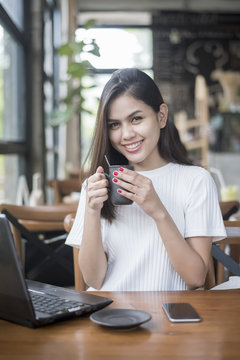  Beautiful business girl working with tablet , smartphone and drinking coffee in coffee shop