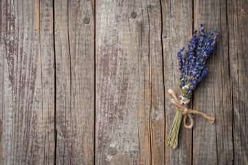 Bunch of lavender flowers on an old wooden table. Close up