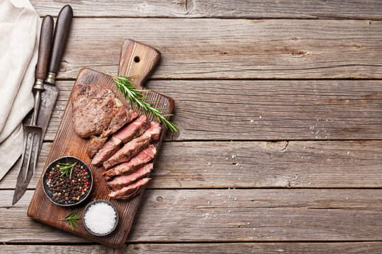 Grilled Beef Steak With Spices On Cutting Board