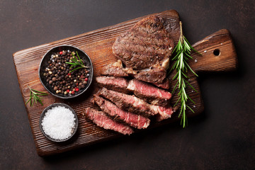 Grilled beef steak with spices on cutting board