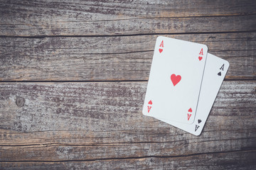 Playing cards on wooden table. Close up