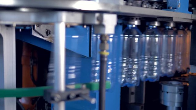 Parisons of PET being transformed into plastic bottles.