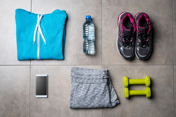 Sport clothing and accessories on gray stone floor