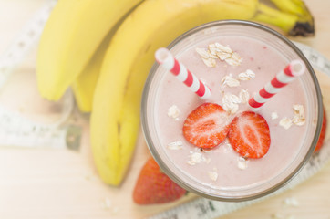 Milk shake with banana, strawberry and oat. Useful smoothies. Top view.
