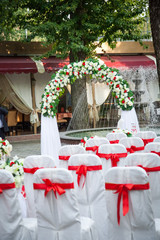 beautiful wedding decor in red and white colors, beautiful wedding decor in red and white colors, decorated chairs