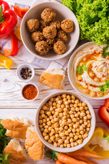 Falafel, pita, hummus and chickpea  with vegetables. Top view