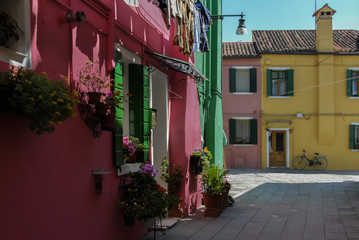 BURANO, ITALY - APRIL 18, 2009: Street with colorful buildings in Burano island, a gracious little town full of canals, near Venice - Italy 