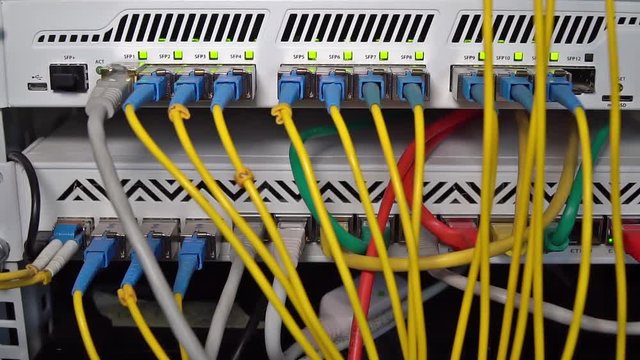 Panel with Internet routers, connected cables and flashing LED indicators