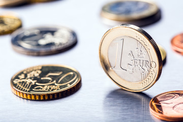 One euro coin on the edge. Euro money currency. Euro coins stacked on each other in different positions.