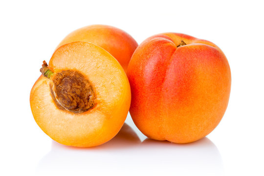 Ripe apricot fruits with slice isolated on white