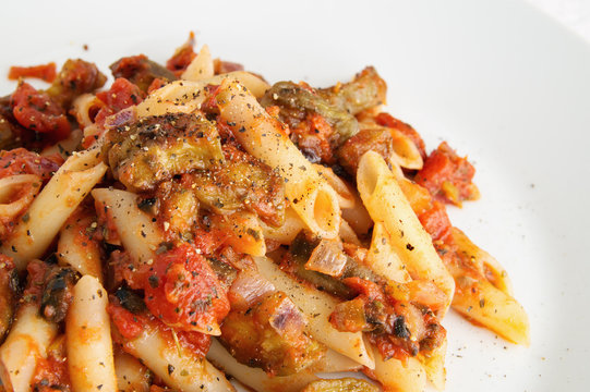 siciliana with eggplant, tomato, onion, garlic, olives, and capers with herbs (basil, parsley, and black pepper)