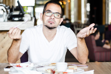 Fototapeta premium funny portrait man eating in restaurant